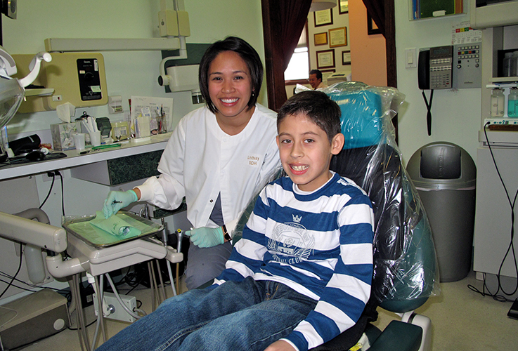 Dr. LaCap and smiling child in dental chair