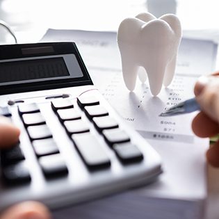 A patient calculating the cost of tooth extractions