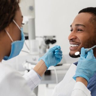 a patient smiling at his dentist 